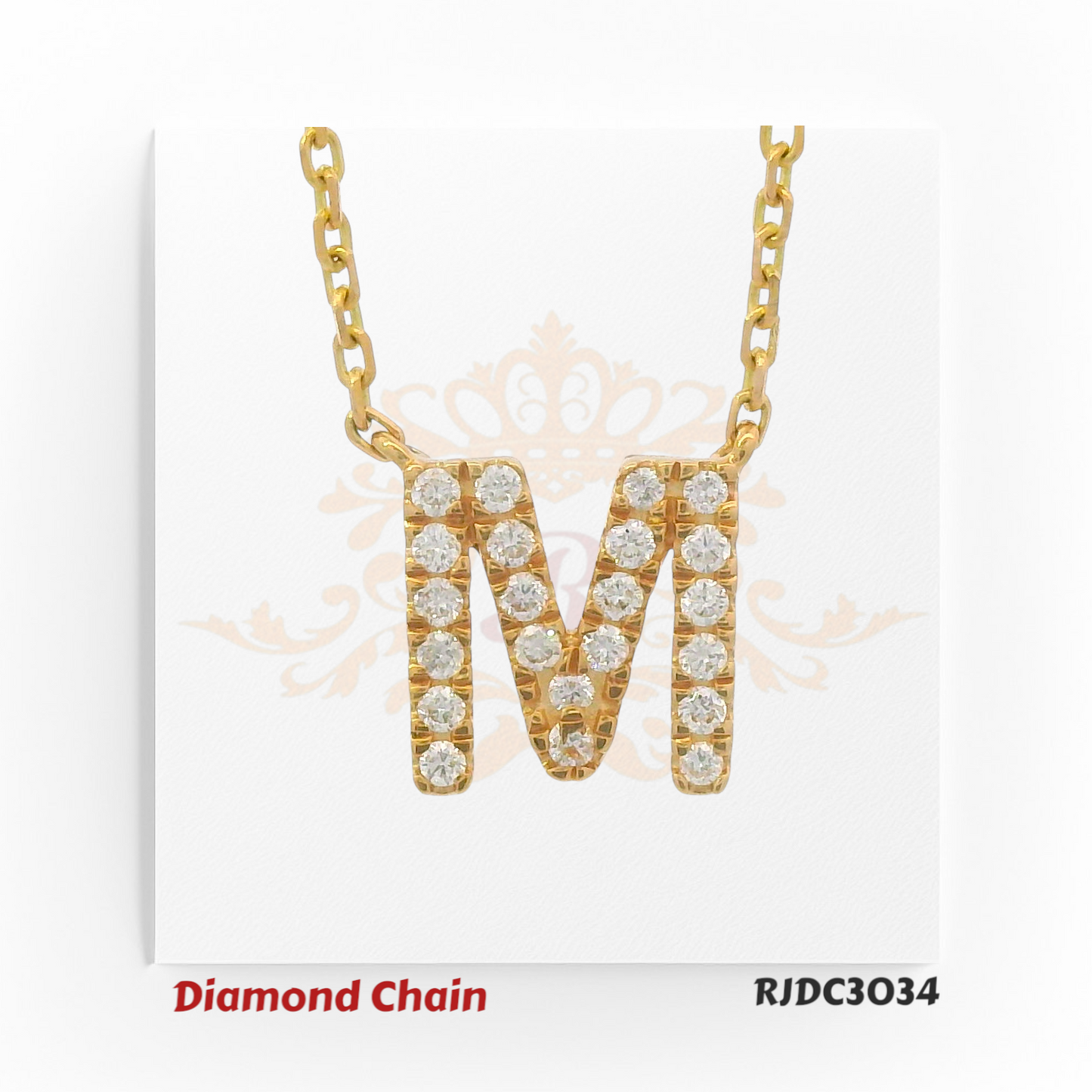 Stylish yellow gold diamond chain featuring a bold pendant in the shape of the letter "M", fully studded with shimmering round-cut diamonds. The pendant hangs from a classic gold link chain, set against a white background with a subtle royal crown and floral pattern. Model number RJDC3034 is noted at the bottom.