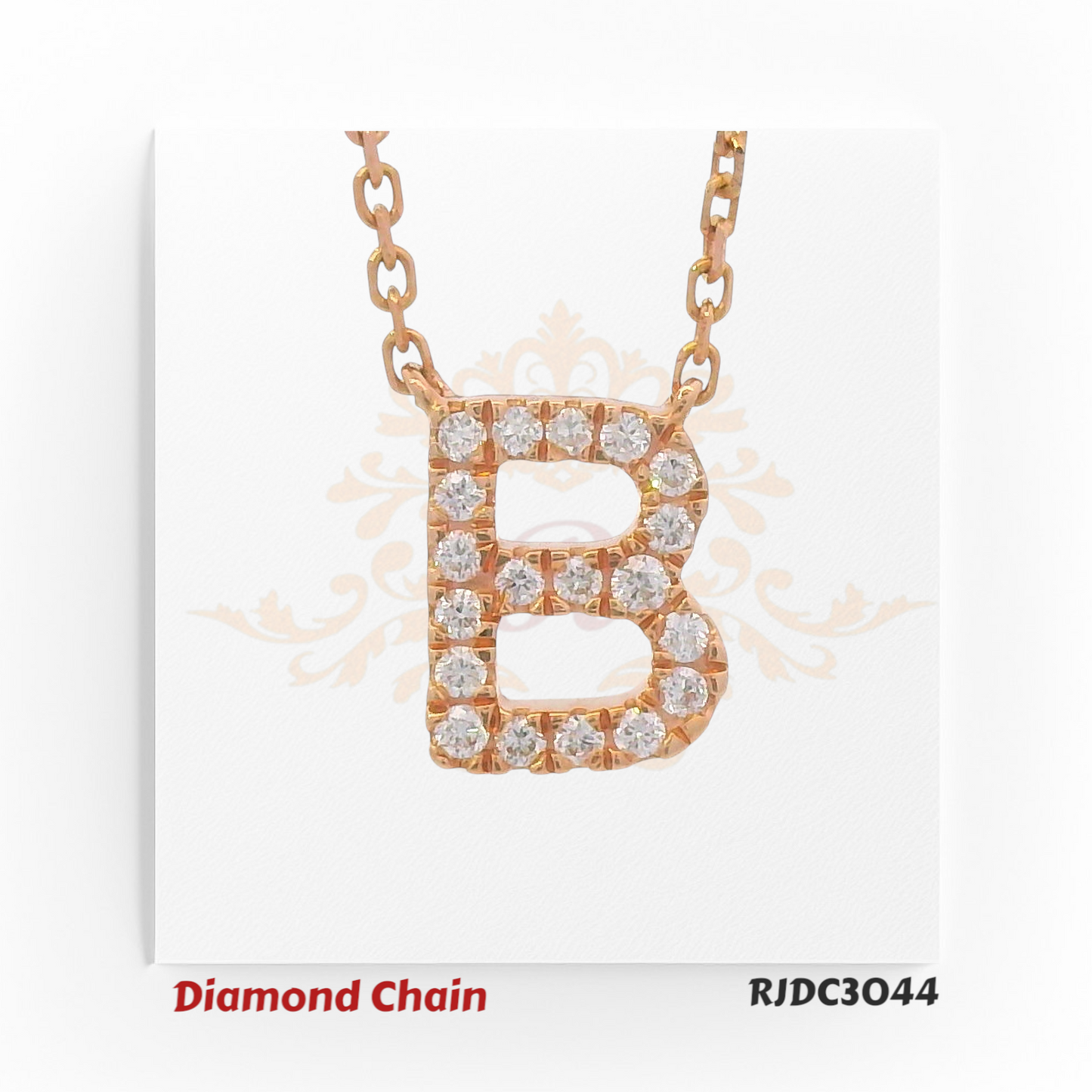 Rose gold diamond chain featuring a bold pendant in the shape of the letter "B", encrusted with brilliant round-cut diamonds. Suspended from a rose gold link chain and set against a white background with a regal crown and floral motif. Model number RJDC3044.