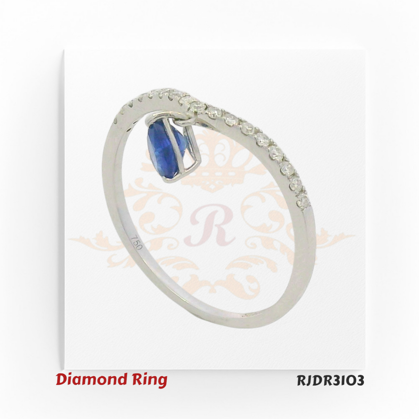 Stylish 18kt white gold V-band ring featuring a pear-shaped sapphire drop, accented with sparkling round diamonds – RJDR3103.