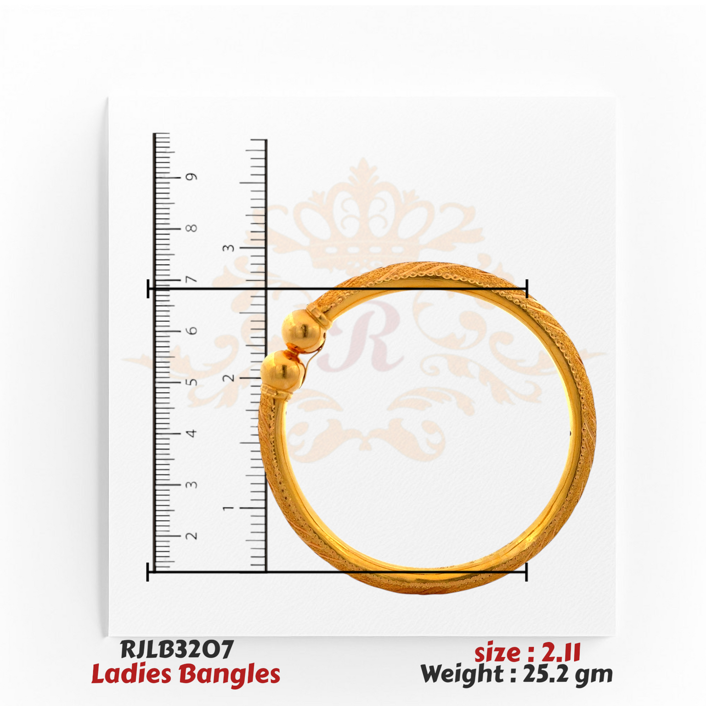 Top view of a gold ladies bangle with intricate engraved patterns along the band and two polished gold ball accents at the clasp, displayed with a ruler for accurate sizing. Model RJLB3207.