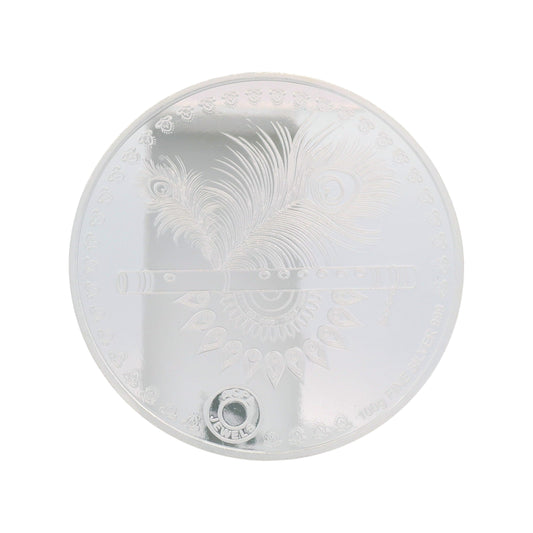 Regal Jewels RJSB0009A 100g fine silver coin engraved with Lord Krishna’s flute and peacock feather design, symbolizing divinity and harmony – a devotional collectible ideal for puja, gifting, and silver investments