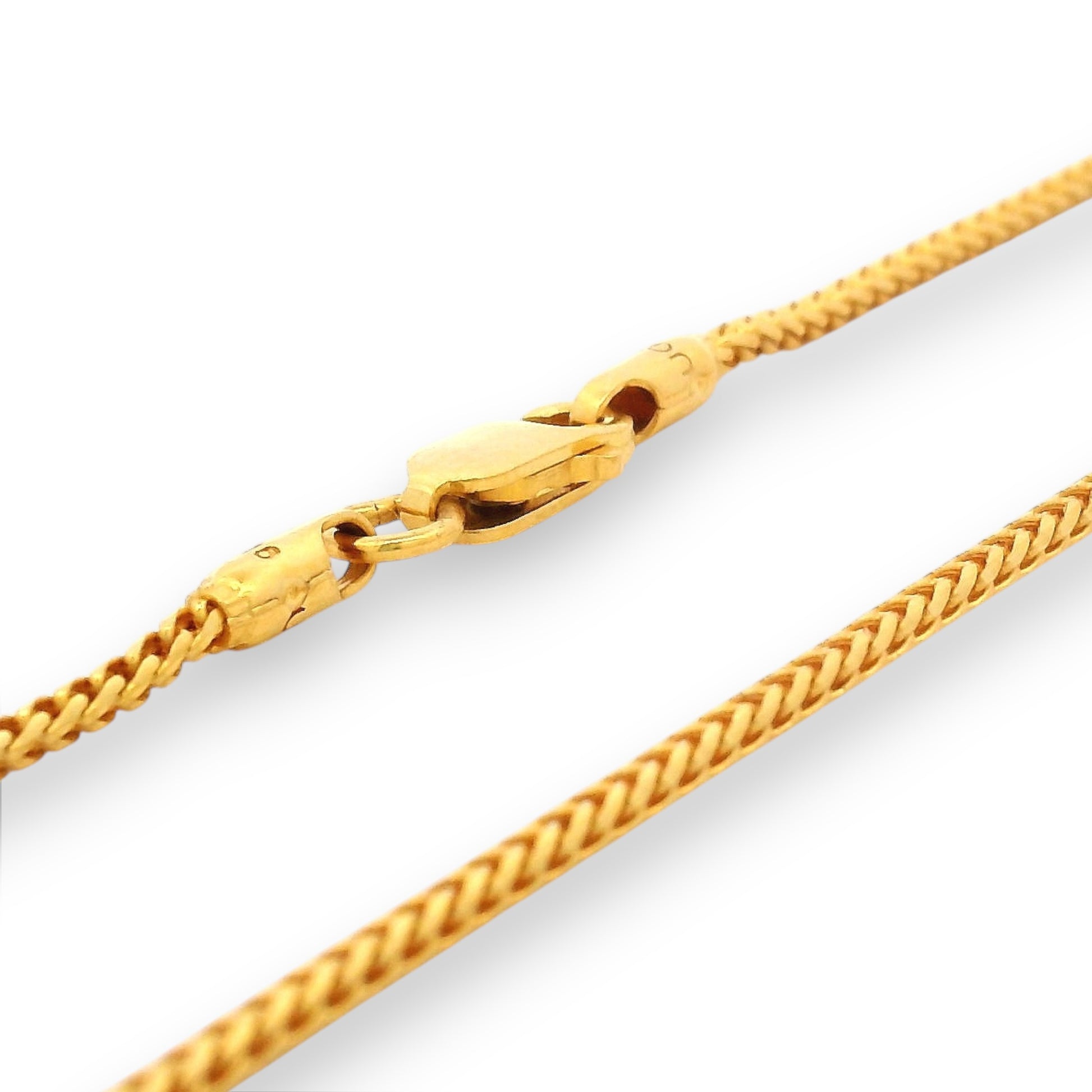 Close-up of 22K gold baby chain (RJC30872a) with a two-tone wheat-link pattern and a sturdy gold clasp. Designed by Regal Jewels Chicago, this elegant and durable chain ensures comfort and safety for newborns and toddlers.