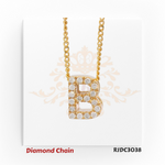 Stunning yellow gold diamond chain featuring a pendant in the form of the letter "B", fully set with brilliant round-cut diamonds. The pendant hangs from a classic gold chain and is displayed against a white background with an elegant crown and floral motif. Model number RJDC3038 is shown at the bottom.