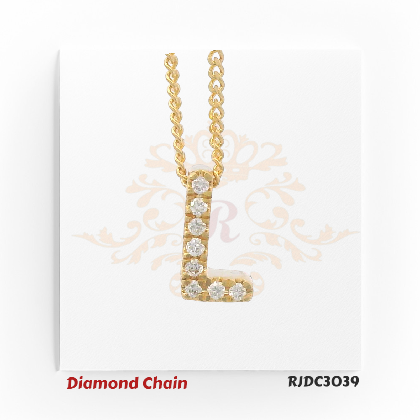 Minimalist yellow gold diamond chain showcasing a pendant in the form of the letter "L", fully encrusted with round-cut diamonds. The pendant is suspended from a sleek, twisted rope-style gold chain, set against a white backdrop with a subtle ornamental crown and floral motif. Model number RJDC3039.