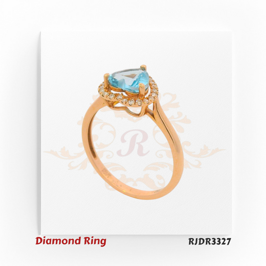 Delicate 18kt rose gold ring showcasing a heart-shaped blue topaz at the center, surrounded by a sparkling diamond halo – RJDR3327.