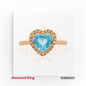 Romantic 18kt rose gold design featuring a brilliant heart-shaped blue topaz, elegantly framed by a halo of shimmering diamonds – RJDR3327.