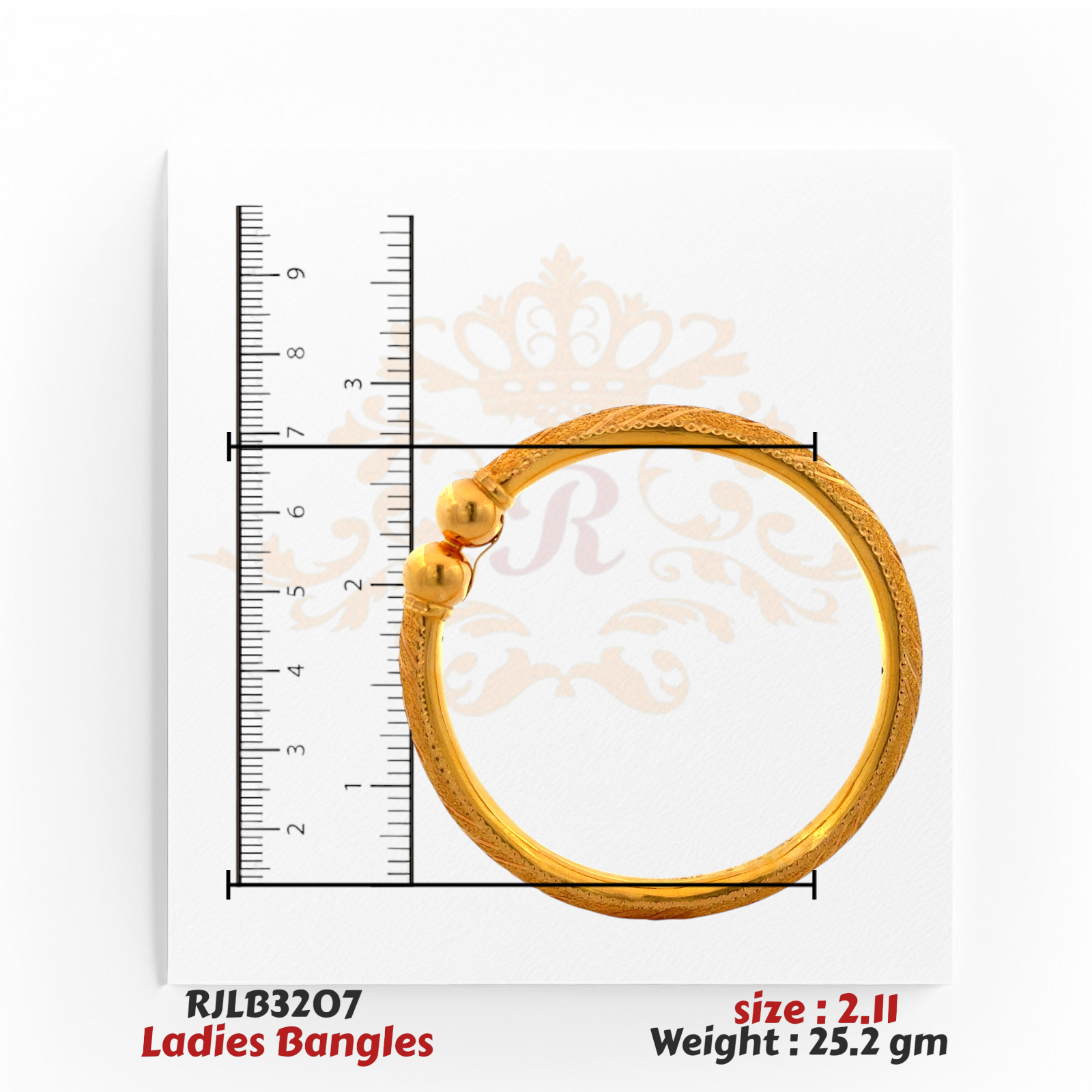 Top view of a gold ladies bangle with intricate engraved patterns along the band and two polished gold ball accents at the clasp, displayed with a ruler for accurate sizing. Model RJLB3207.