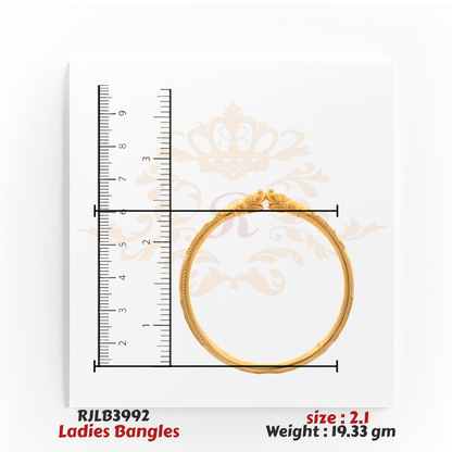 Top view of a gold ladies bangle featuring twin peacock head motifs at the clasp and intricate detailing along the band, displayed with a ruler for precise sizing. Model RJLB3992.
