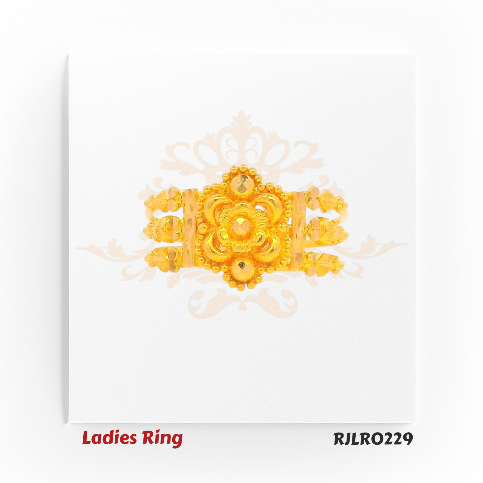 Gold statement ring with a broad band, featuring a detailed central flower, layered petal patterns, and intricate golden beading for a rich traditional look. Model RJLR0229.