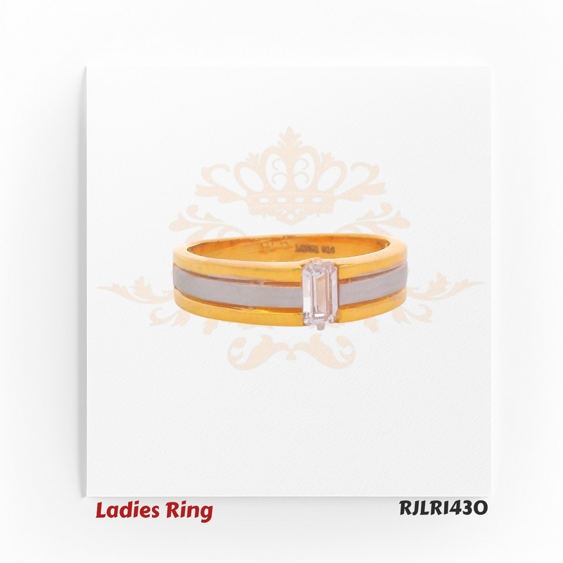 Front view of a minimalist ladies gold ring displaying the elongated baguette-cut stone aligned horizontally within a two-tone band. Model RJLR1430.