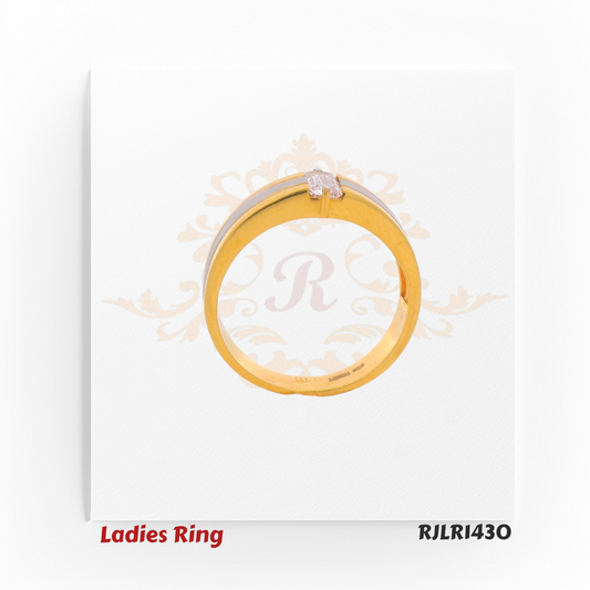 Side profile view of a contemporary ladies gold ring showing the raised baguette stone setting and contrasting rhodium strip along the shank. Model RJLR1430.