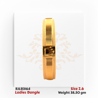 Front view of a bold gold ladies bangle featuring a textured ridged pattern along the band and a prominent raised crown emblem at the center, adding a regal and distinctive touch. Model RJLB3164.