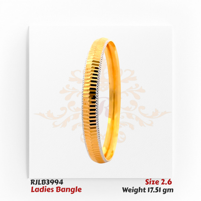 Angled view of a gold ladies bangle featuring a sleek central row of alternating gold and black faceted segments, bordered by delicate white-edged detailing for a modern and elegant finish. Model RJLB3994.