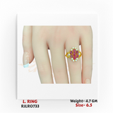 22k yellow gold ladies ring with a red stone floral cluster surrounded by shimmering white gems, displayed on a hand. Model RJLR0733