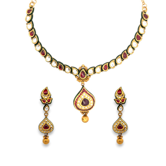 Elegant 22kt gold Kundan necklace set featuring teardrop motifs with red and white polki stones, green enamel edging, and matching earrings. Ideal for bridal, festive, and traditional occasions from Regal Jewels Chicago.