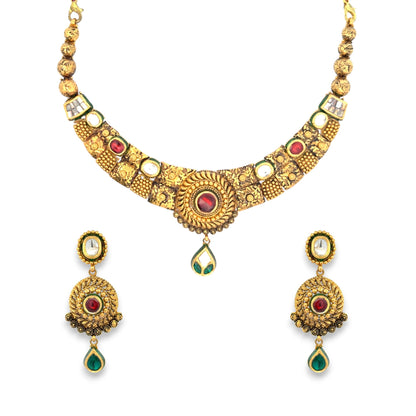 Traditional 22kt gold antique necklace set showcasing intricate Kundan craftsmanship with red and green gemstones, ornate gold patterns, and matching earrings. Perfect for bridal, festive, and traditional wear from Regal Jewels Chicago.