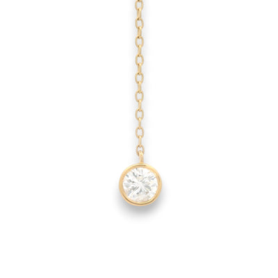 closeup of 18KT yellow gold diamond drop chain with bezel-set round brilliant diamond pendant by Regal Jewels