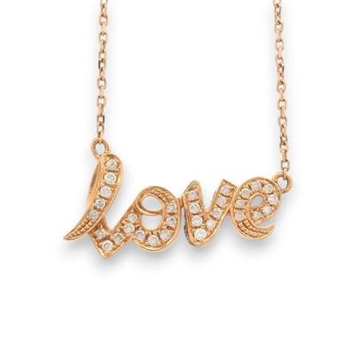 closeup of 18KT yellow gold “Love” script pendant chain with natural diamond accents by Regal Jewels