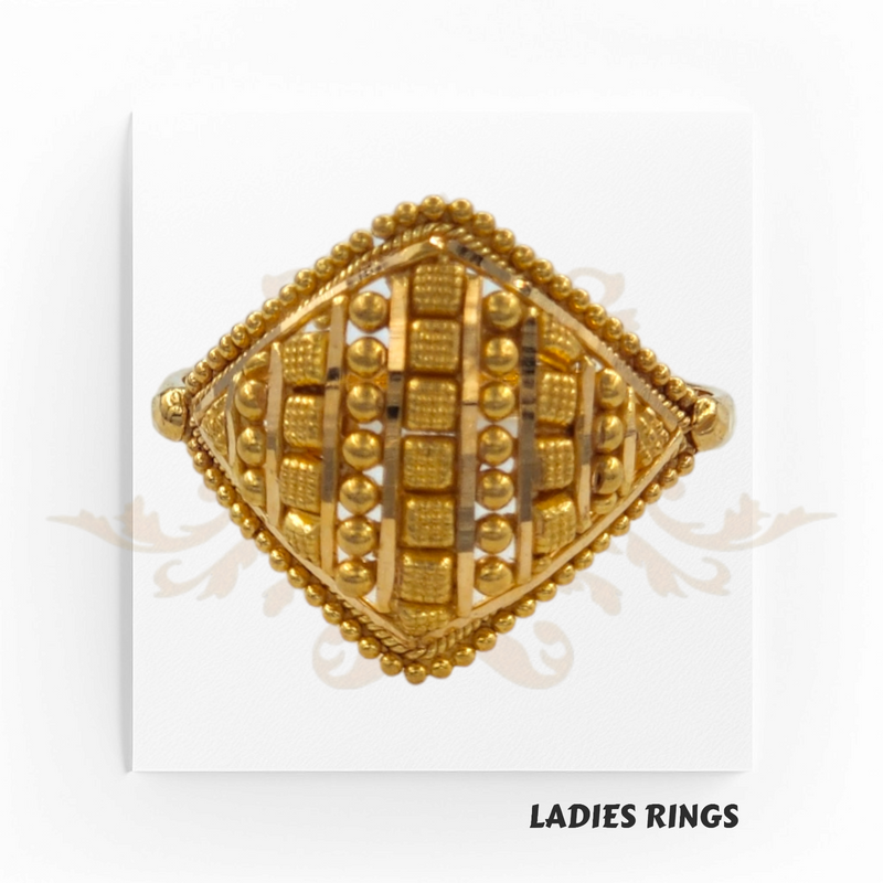 This is an image of a gold ladies ring with a detailed square design featuring various raised geometric patterns and embellishments. The label 