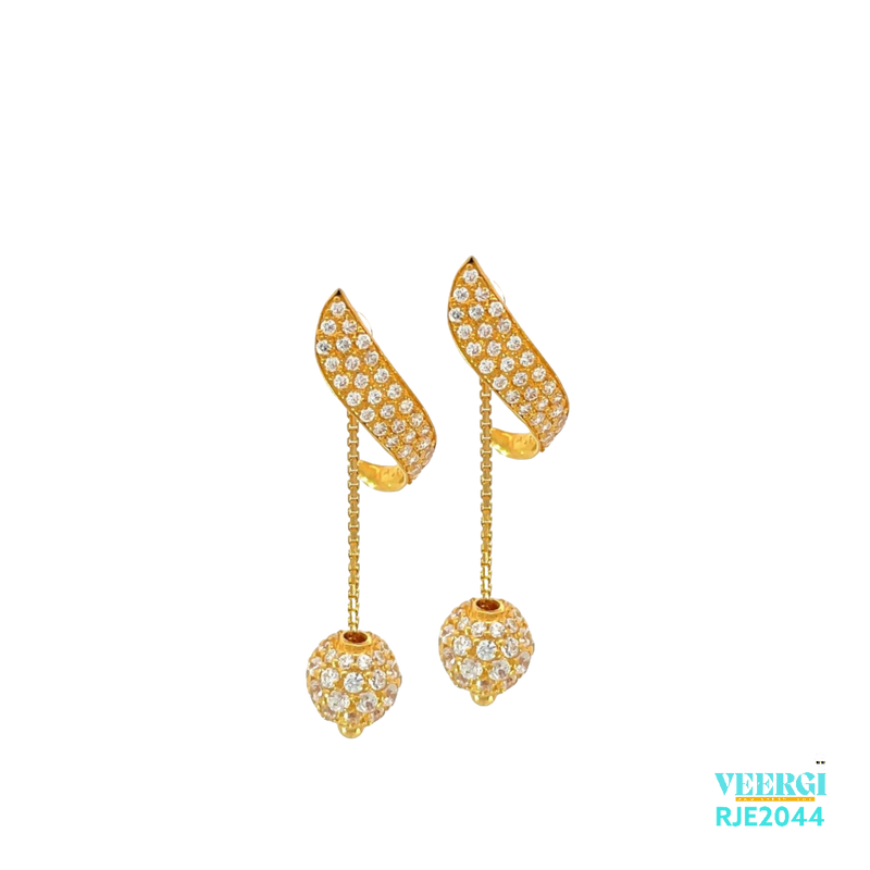 VeerGi Tops Earrings RJE2044 showcases a stunning and fashionable design. These 22kt gold earrings feature a unique modern shape with cubic zirconia stones, a screw back post, and a hanging chain with a disco ball adorned with cubic zirconia stones. They weigh 5.30 grams and have a height of 3.3cm and a width of 0.4cm.